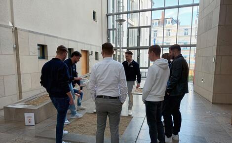 Eine kleine Gruppe Studierender spielt ein Spiel während der Campus-Rallye